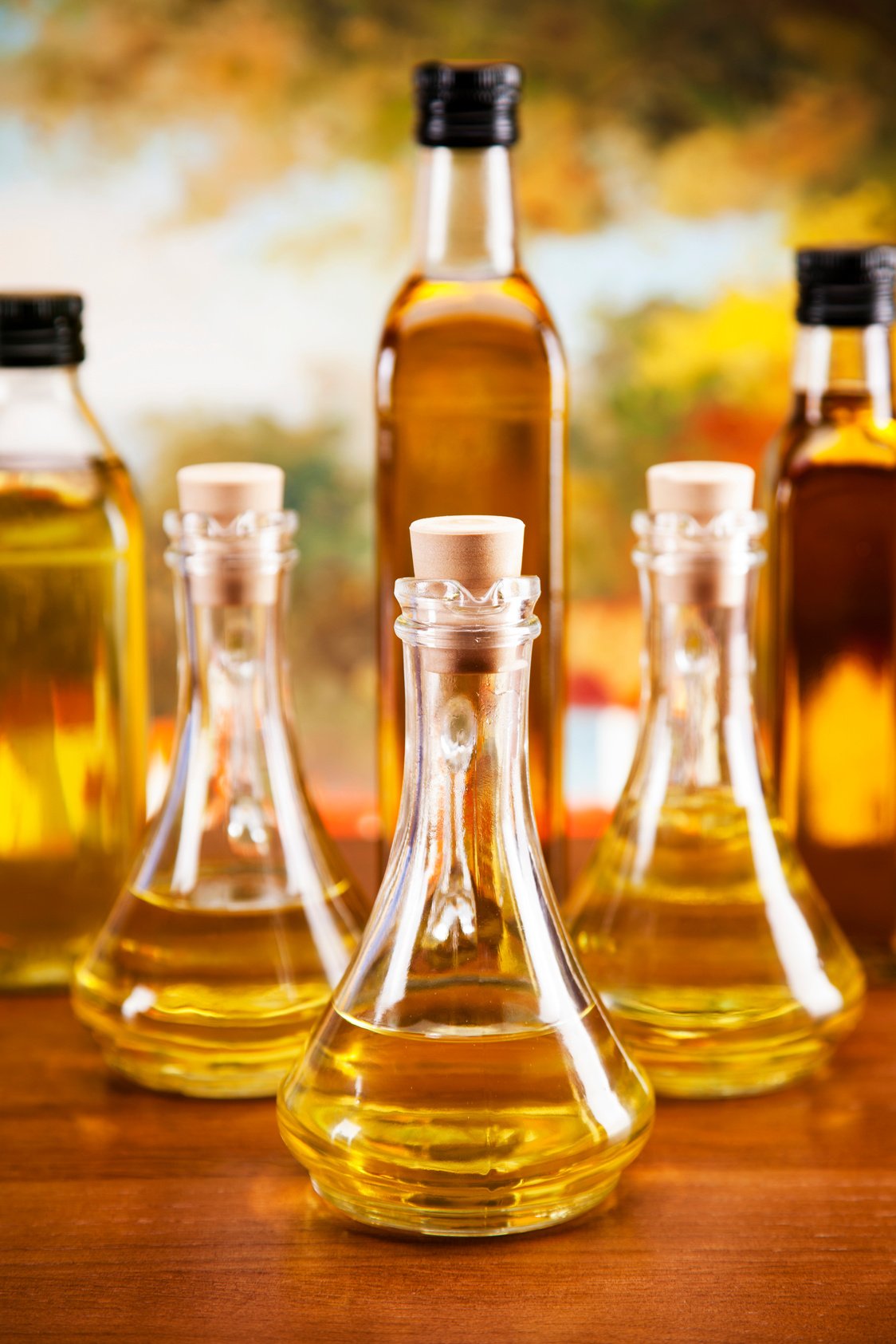 Olive oil and olives set on wooden table